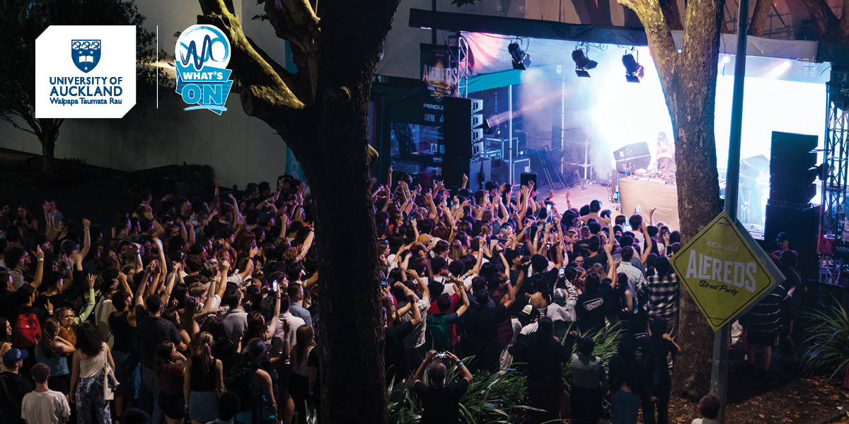 Large group of students enjoying live band performance on Alfred street