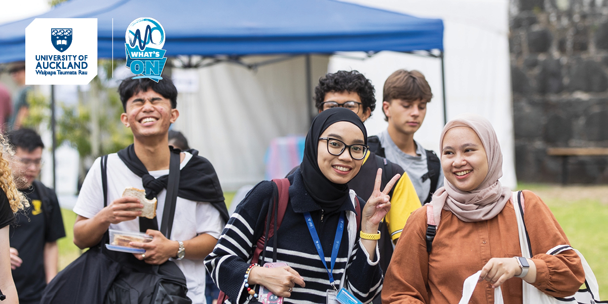 Students outside Club Expo. One is looking at the camera doing a peace sign