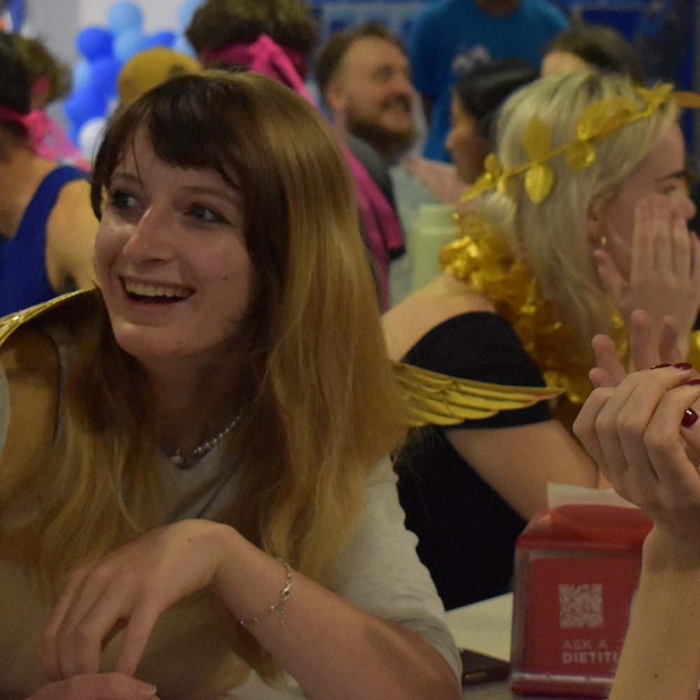 Two students dressed up enjoying quiz night