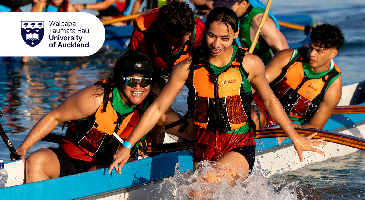 Students paddling a waka on the water at Great Waka Ama Race